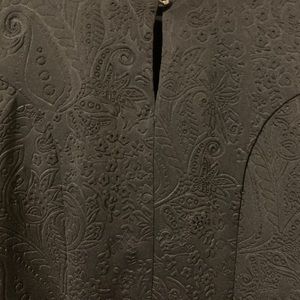 Black peplum blouse with detailed fabric